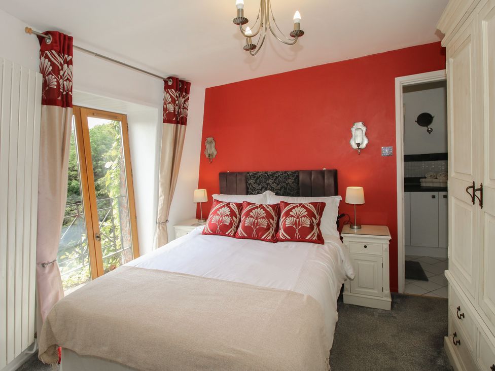 A bedroom with a bed and window at Hadley Park Windmill near Telford