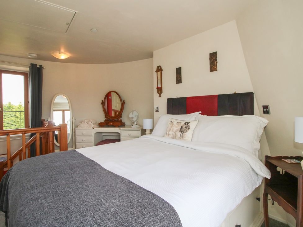 A bedroom with a bed and dresser at Hadley Park Windmill near Telford
