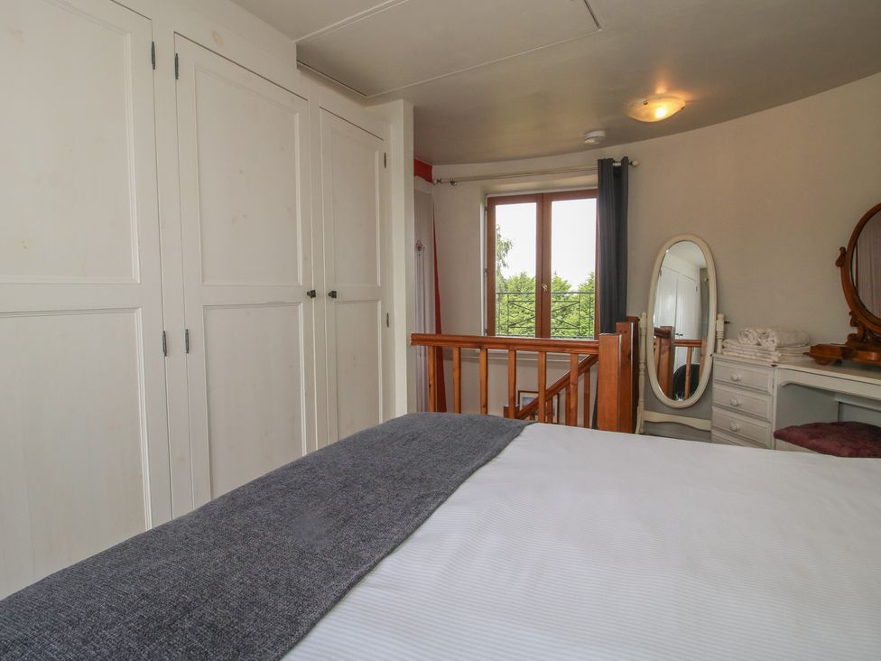 A bedroom with a bed and wardrobe at Hadley Park Windmill near Telford