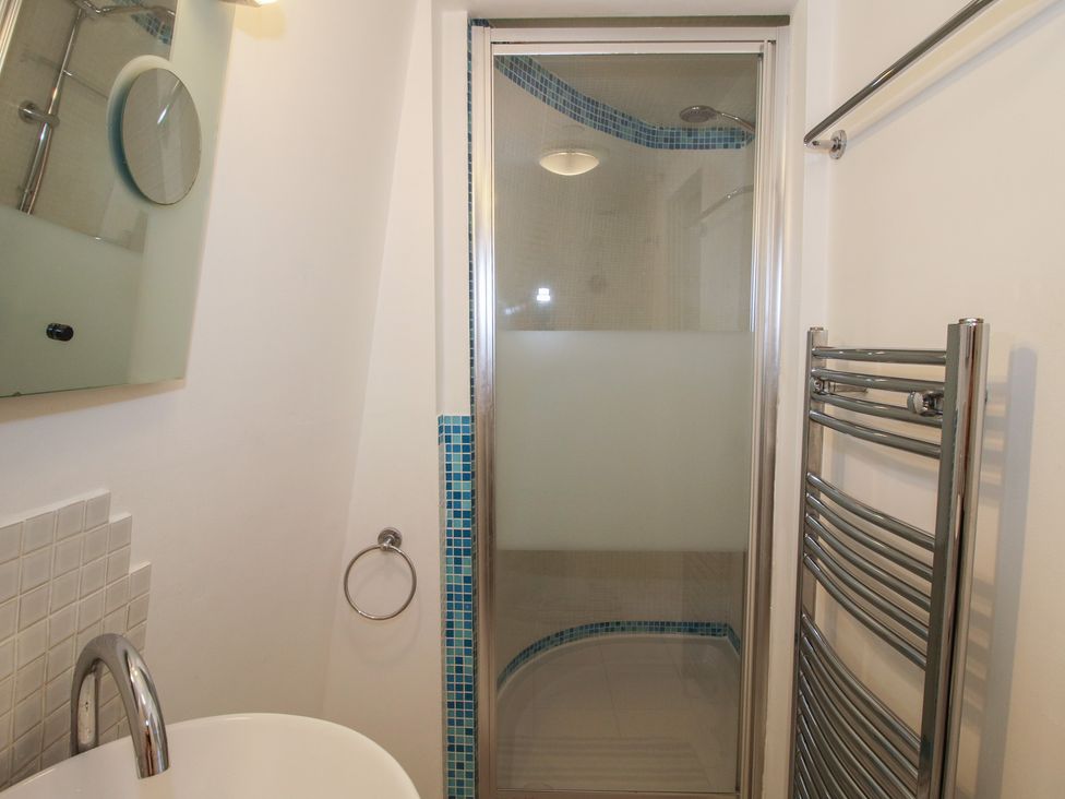 A bathroom with a shower and bathtub at Hadley Park Windmill near Telford