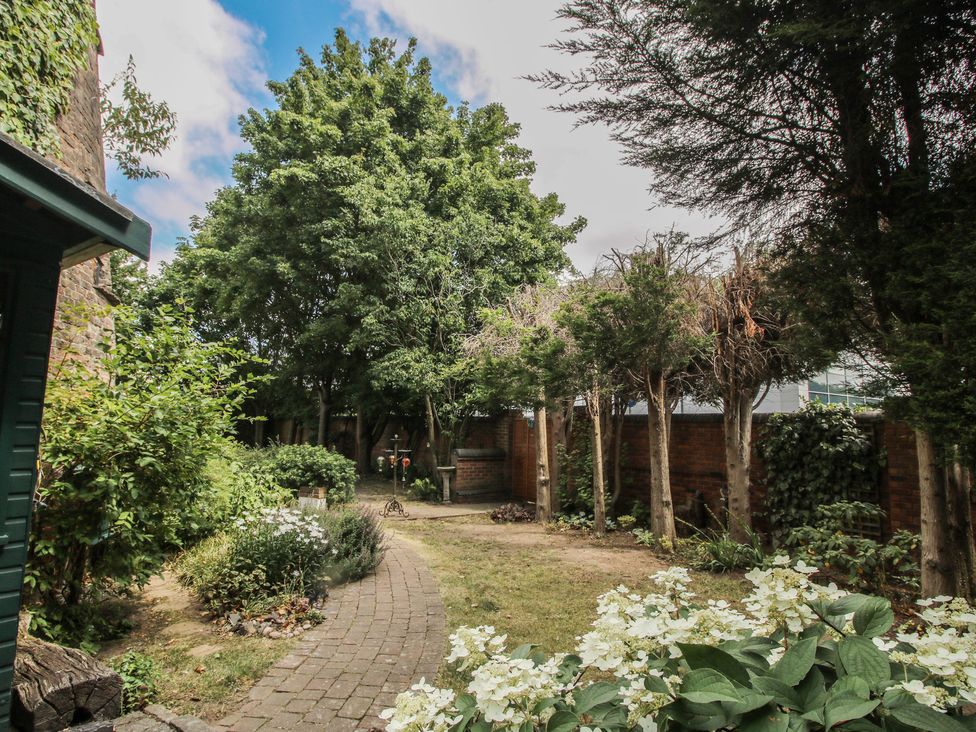 A garden area with trees and a pathway at Hadley Park Windmill near Telford