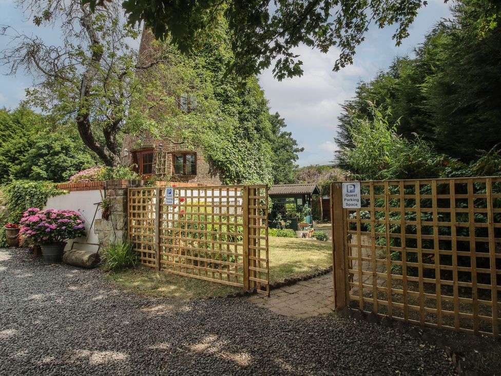 A garden entrance with gravel path and flowerpots at Hadley Park Windmill near Telford