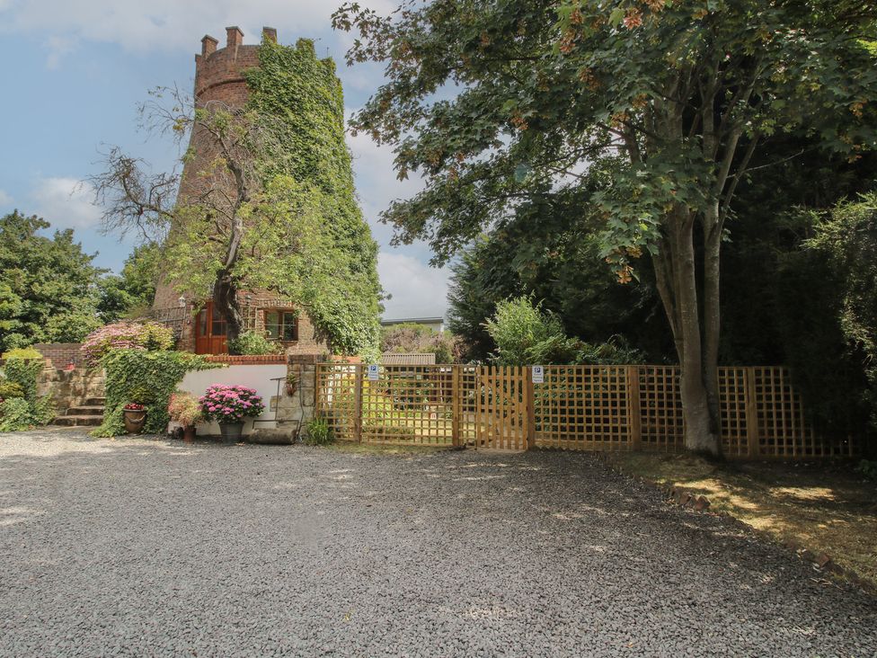 An outdoor area with a tower and gate at Hadley Park Windmill near Telford
