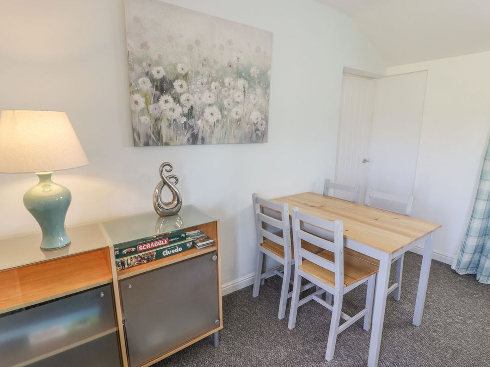 A dining room with a table and chairs at Falconers Cottage