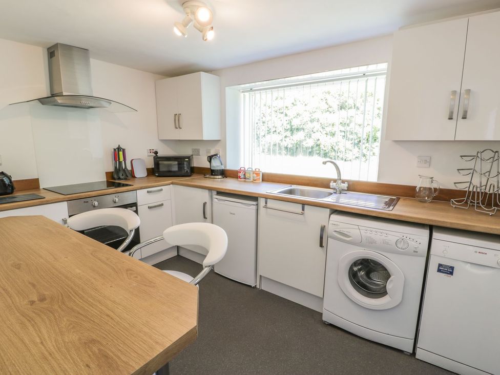 A kitchen with appliances and workspace at Falconers Cottage 