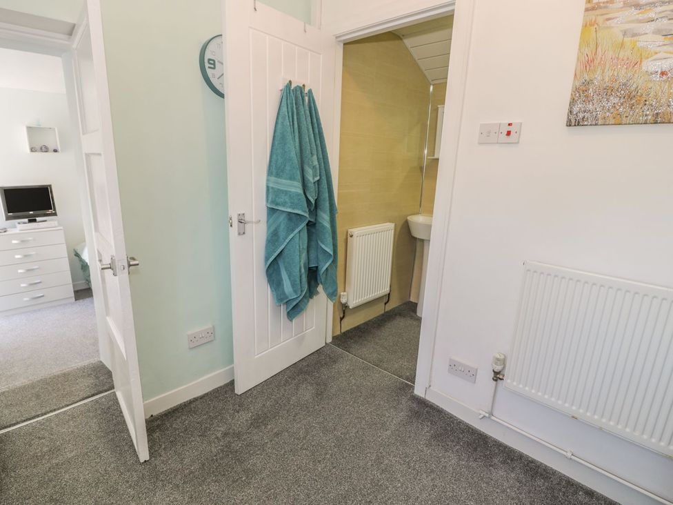 A bathroom with a towel hanging and a sink at Falconers Cottage