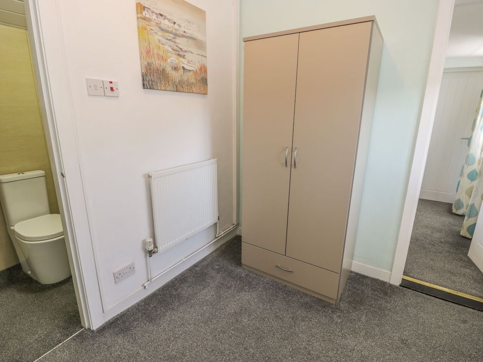 A cabinet and toilet in a bathroom at Falconers Cottage