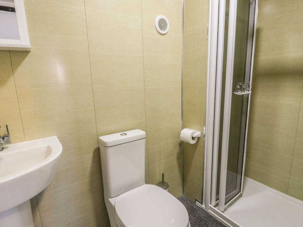 A bathroom with a toilet and shower at Falconers Cottage