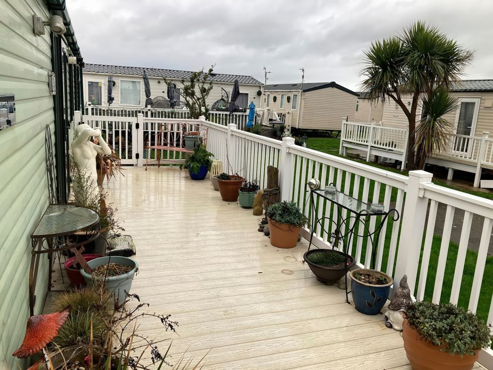 An outdoor area with potted plants and a mannequin at Beachside in Towyn