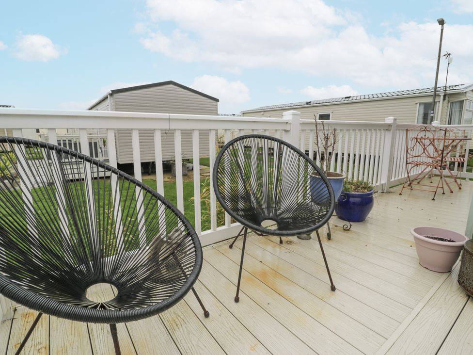 An outdoor area with chairs and planters at Beachside in Towyn