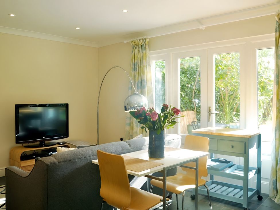A living room with a television, sofa, and dining table at 45 School Road Birmingham