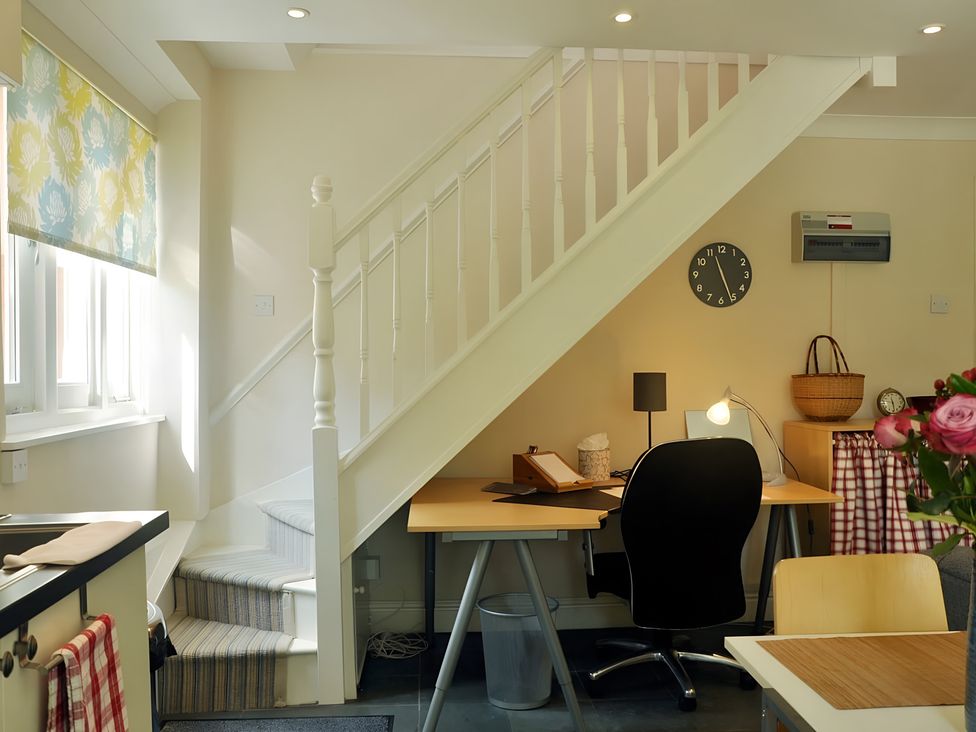 A study area with desk and chair under a staircase at 45 School Road Birmingham