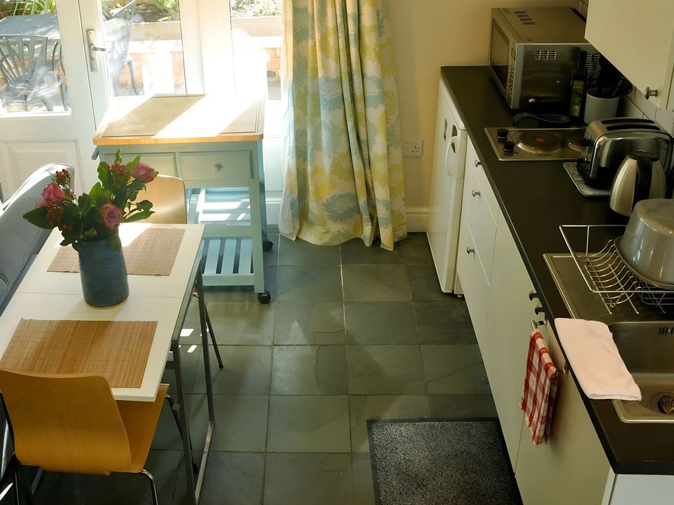 A kitchen with a table and flowers at 45 School Road Birmingham