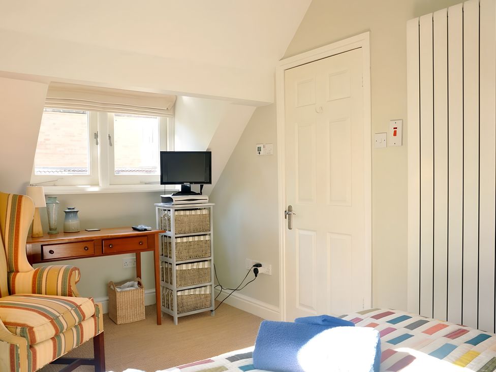 A bedroom with a desk and television at 45 School Road in Birmingham