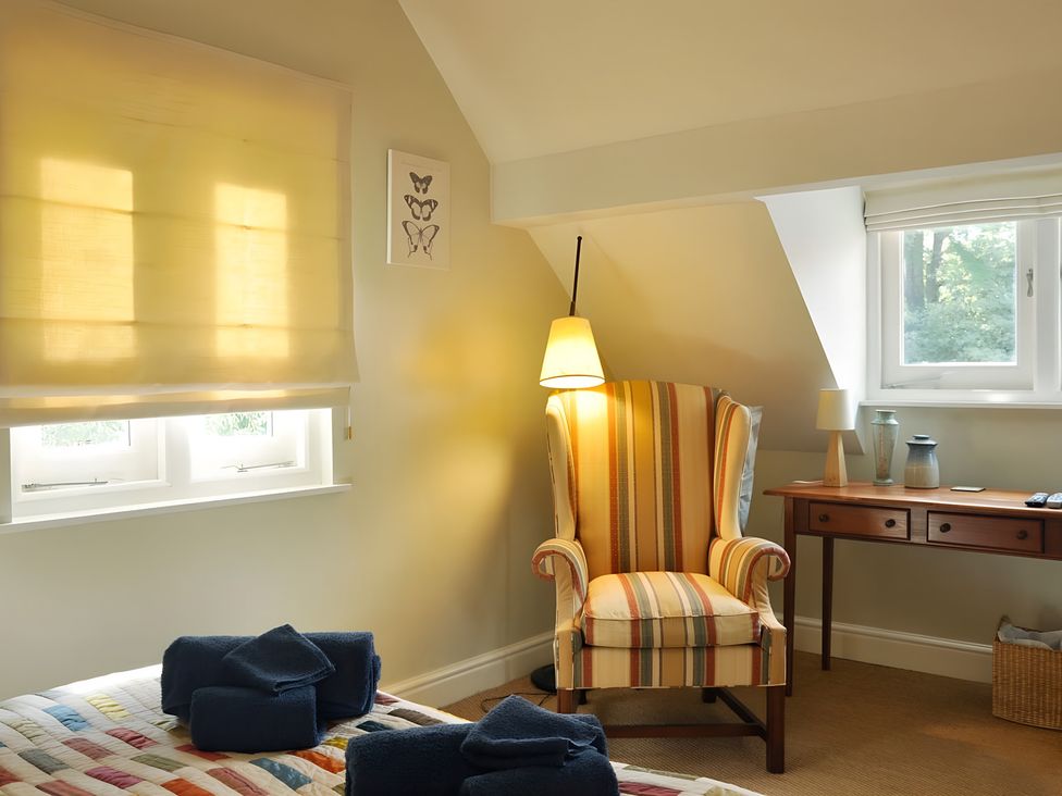 A bedroom with a chair and window at 45 School Road in Birmingham