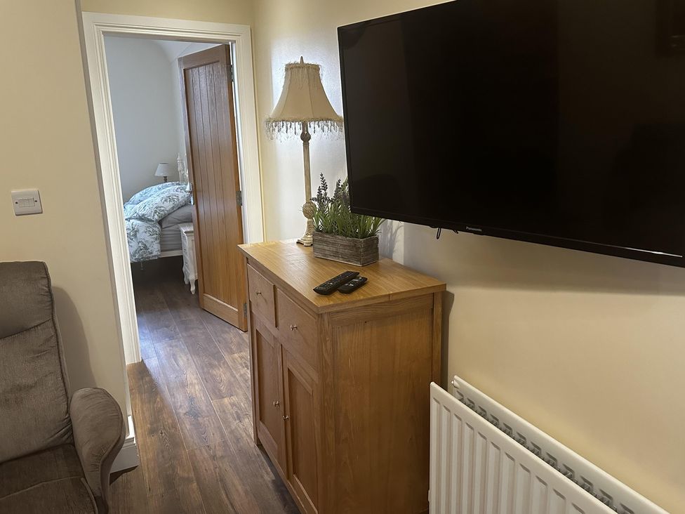 A living room with a television mounted on the wall at The Rocks in Newry