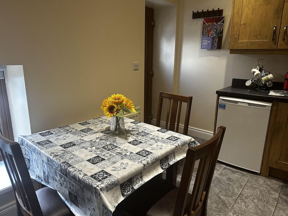 A kitchen with a table and chairs at The Rocks in Newry