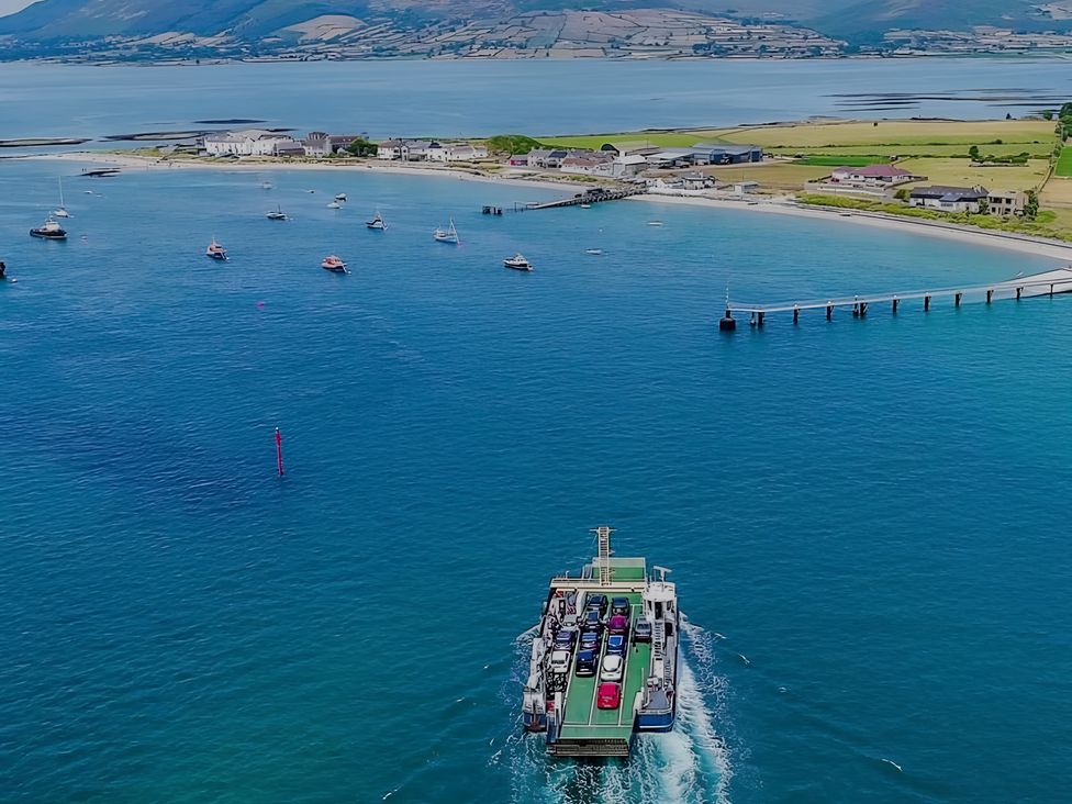 A ferry moving towards a pier with boats in the water at The Rocks in Newry
