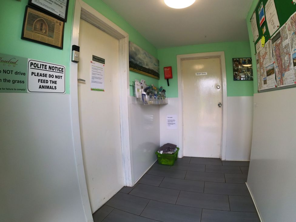 A hallway with reception door and signs at Rosebud Meadow Pod 2 in Malvern