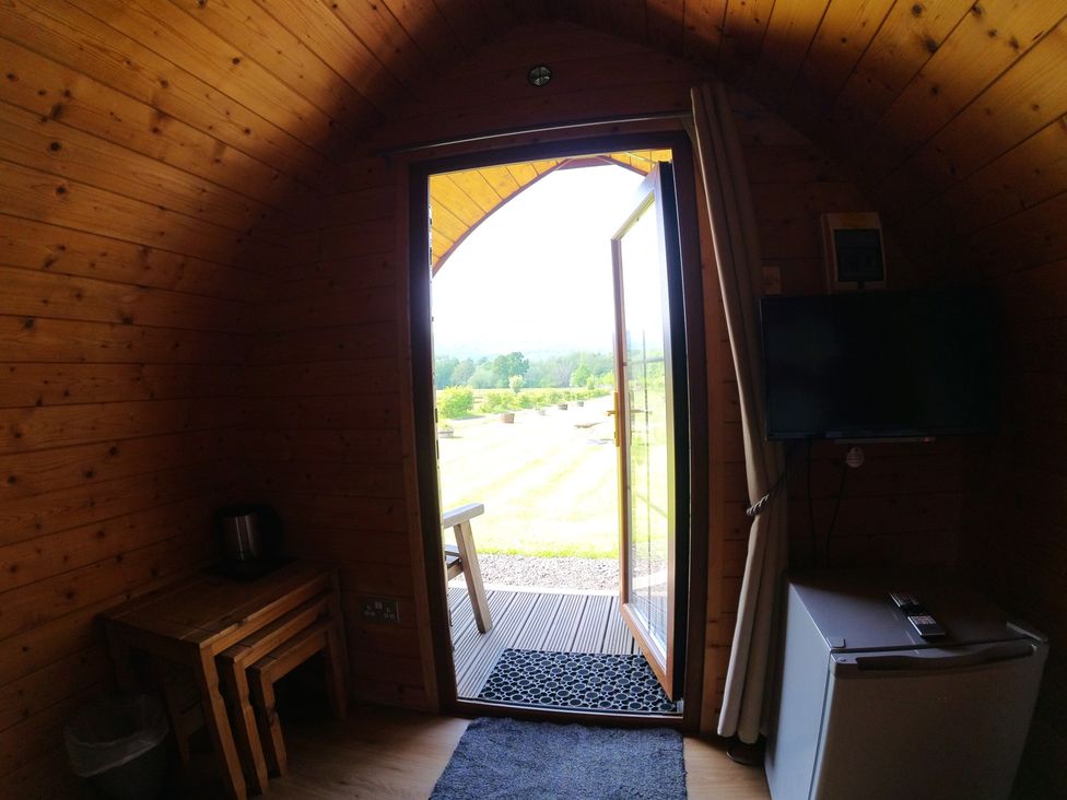 A room with a door open to the outdoors at Rosebud Meadow Pod 3 Malvern