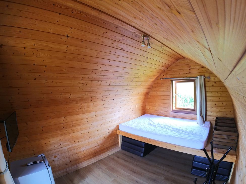 A bedroom with a bed and a window at Rosebud Meadow Pod 3 Malvern