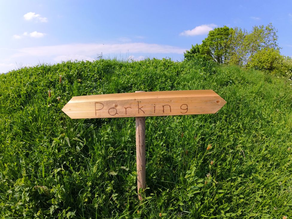 A wooden sign indicating parking location at Rosebud Meadow Pod 4 in Malvern