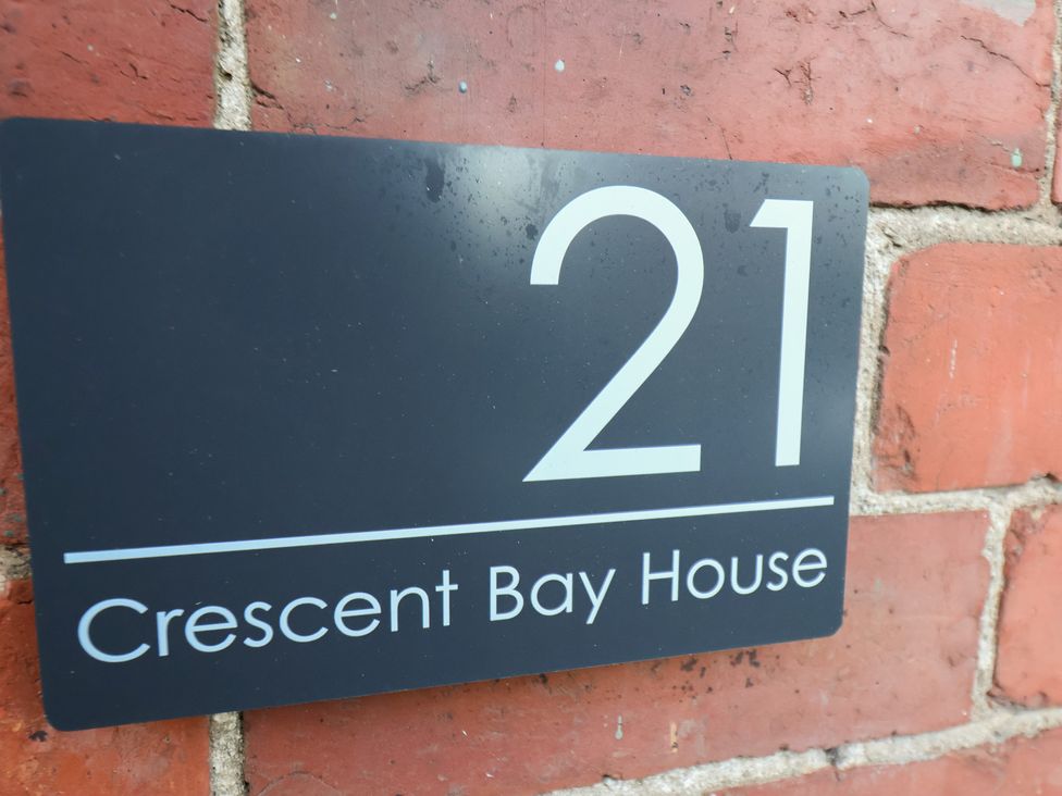 A house number and name sign at Crescent Bay House in Filey