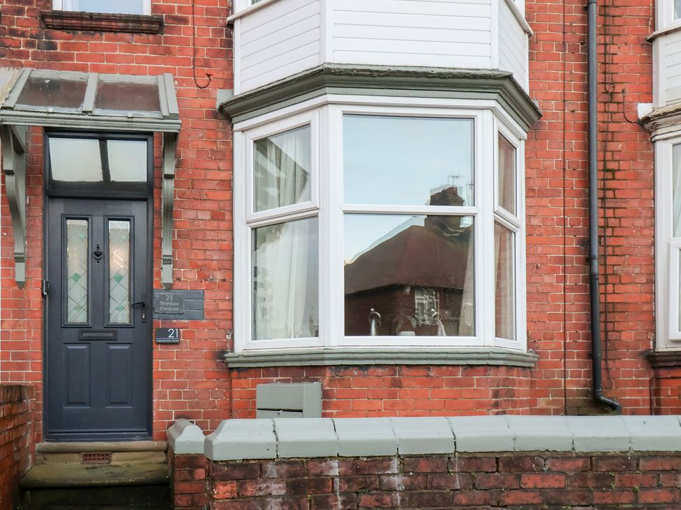 A door and window of a brick house at Crescent Bay House in Filey