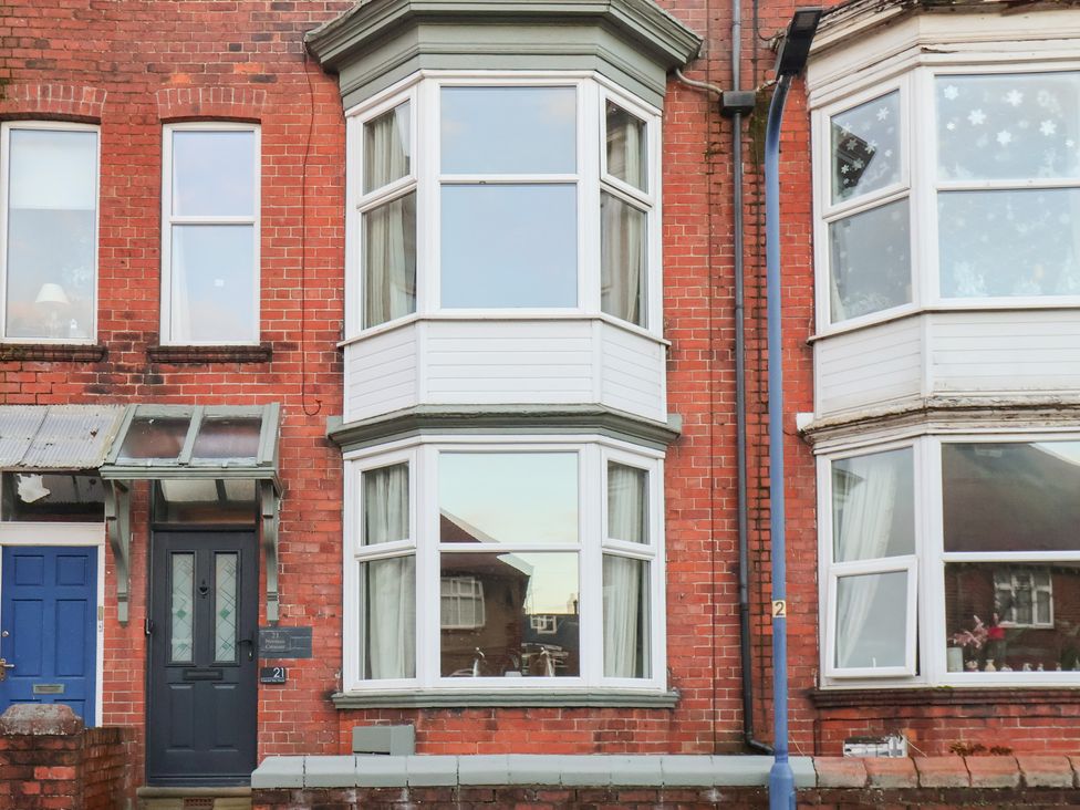 An exterior view of a house with a bay window at Crescent Bay House in Filey