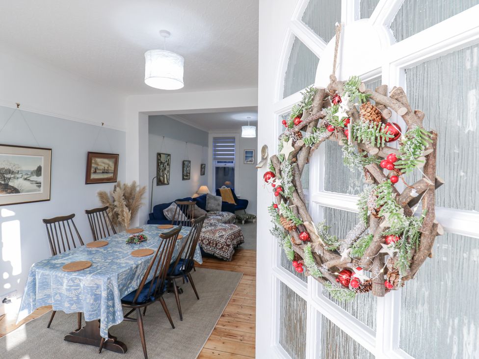 A dining room with a table and chairs at Beachside Terrace in Harwich