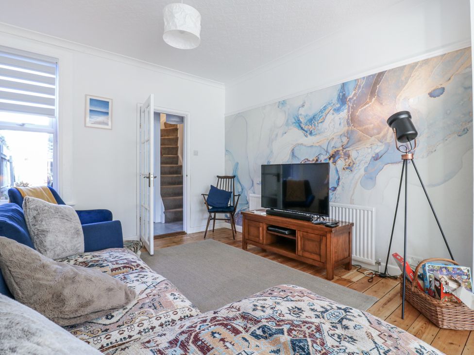 A living room with a television and a sofa at Beachside Terrace in Harwich