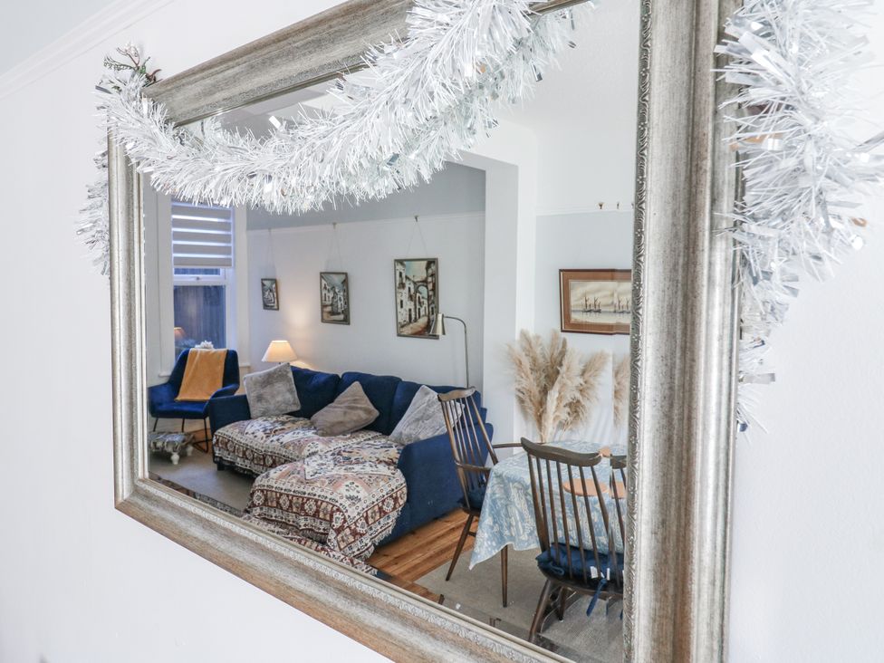 A living room with a sofa and dining area at Beachside Terrace in Harwich