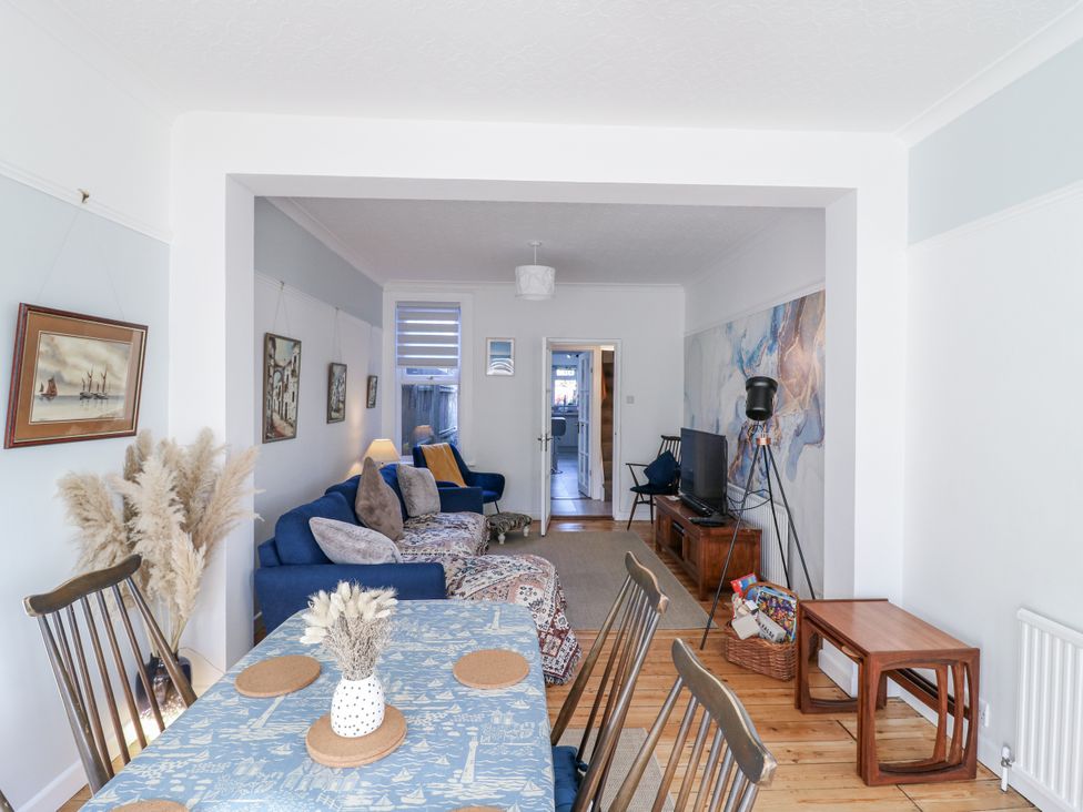 A living room with a dining area and sofa at Beachside Terrace in Harwich