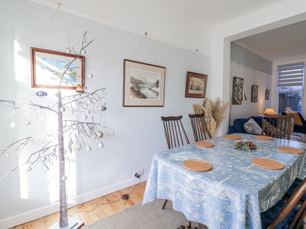 A dining room with a table and chairs at Beachside Terrace in Harwich