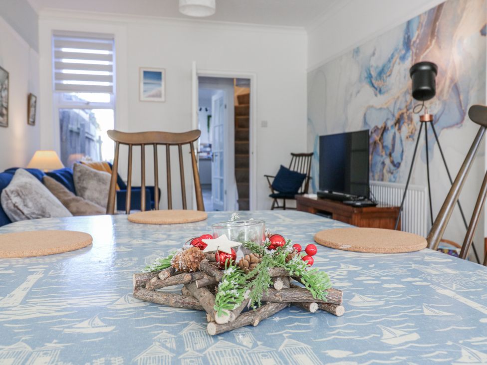 A dining room with a table and chairs at Beachside Terrace in Harwich