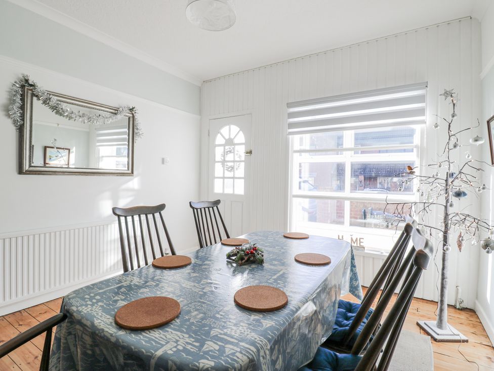A dining room with a table and chairs at Beachside Terrace, Harwich