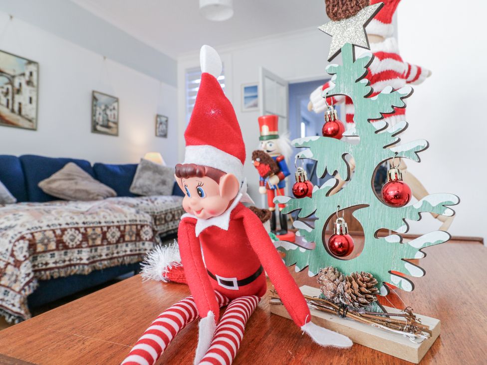 An elf doll and a decorative tree in a living room at Beachside Terrace Harwich
