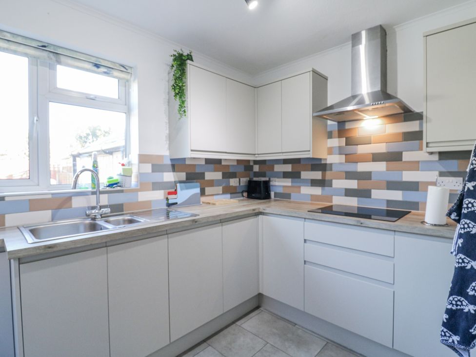 A kitchen with a sink and cabinets at Beachside Terrace in Harwich
