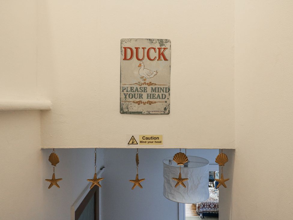 A staircase with signs and decorations at Beachside Terrace in Harwich