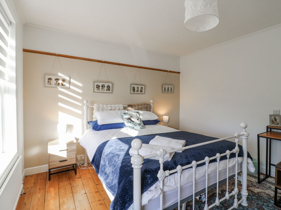 A bedroom with a bed and bedside table at Beachside Terrace in Harwich