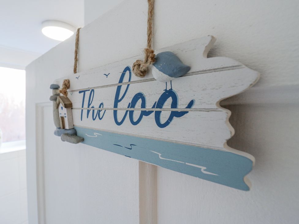 A decorative sign reading 'The loo' at Beachside Terrace, Harwich
