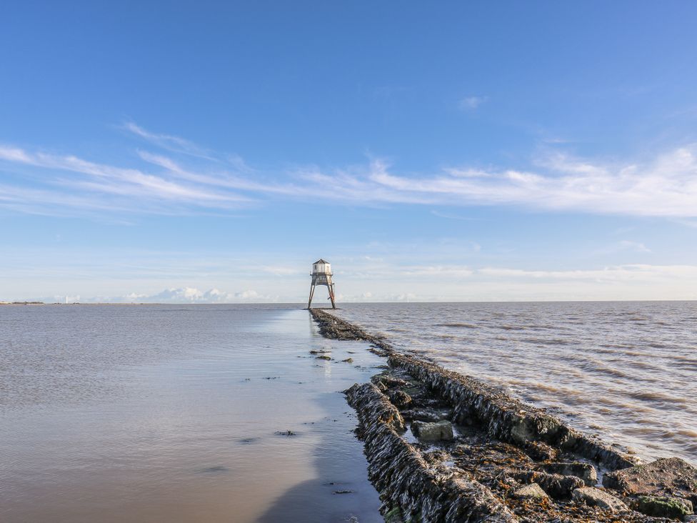 A lighthouse on a rock pier by the sea at Beachside Terrace Harwich
