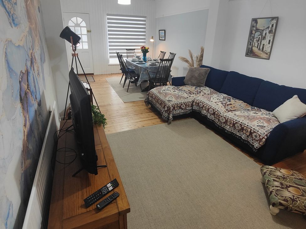 A living room with a sofa and dining table at Beachside Terrace in Harwich