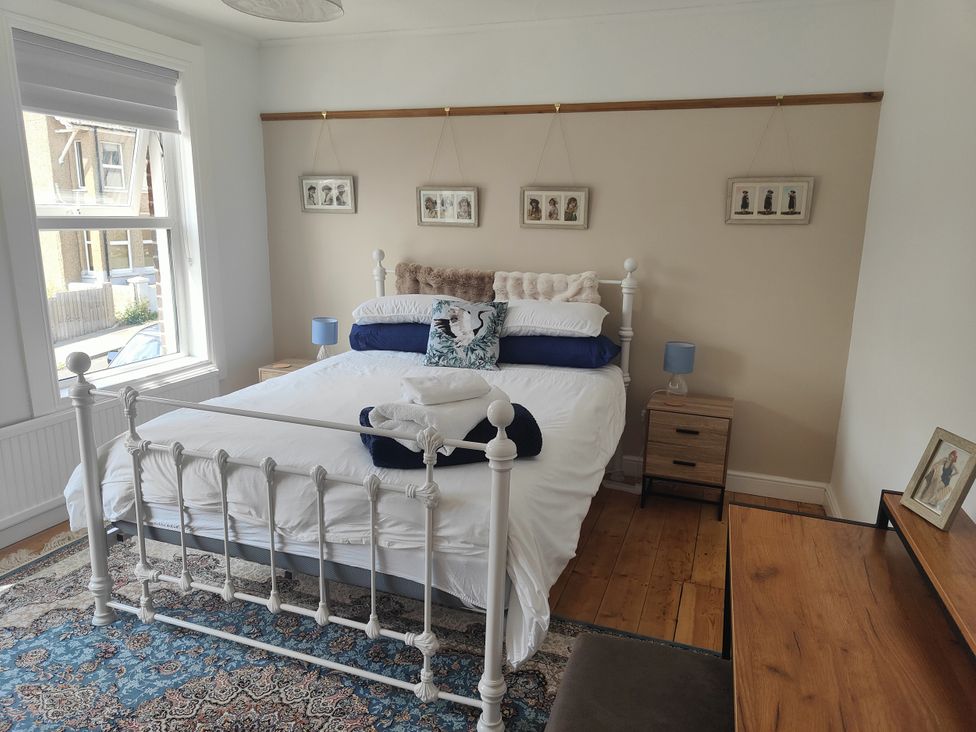 A bedroom with a bed and bedside table at Beachside Terrace Harwich