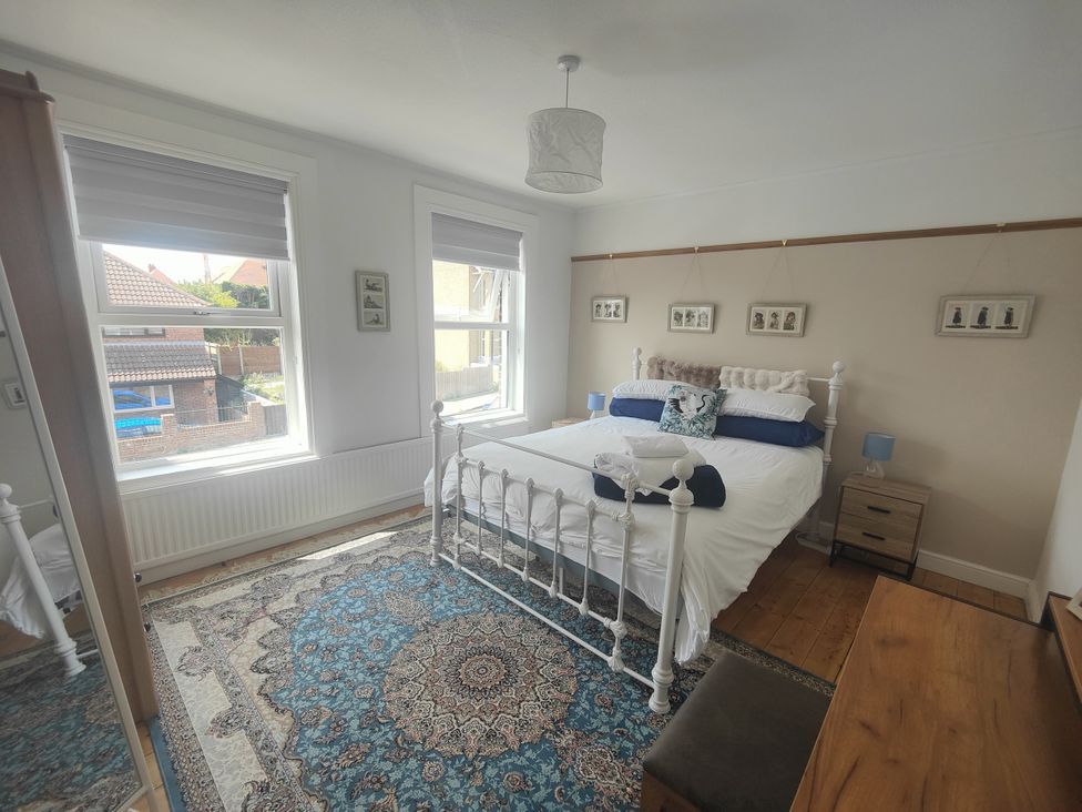 A bedroom with a bed and bedside tables at Beachside Terrace, Harwich