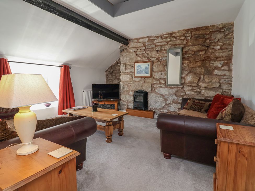 A living room with a sofa and coffee table at The Sun Inn Apartment in Mold