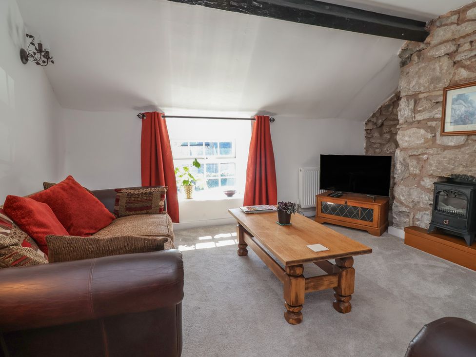 A living room with a sofa and coffee table at The Sun Inn Apartment in Mold