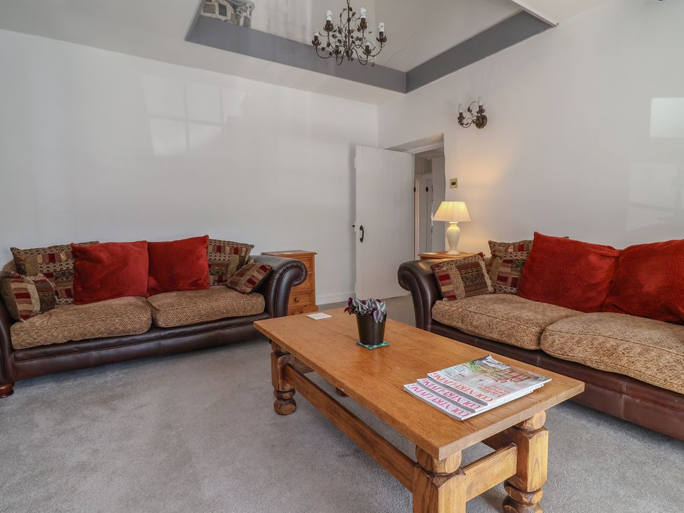 A living room with sofas and a coffee table at The Sun Inn Apartment in Mold