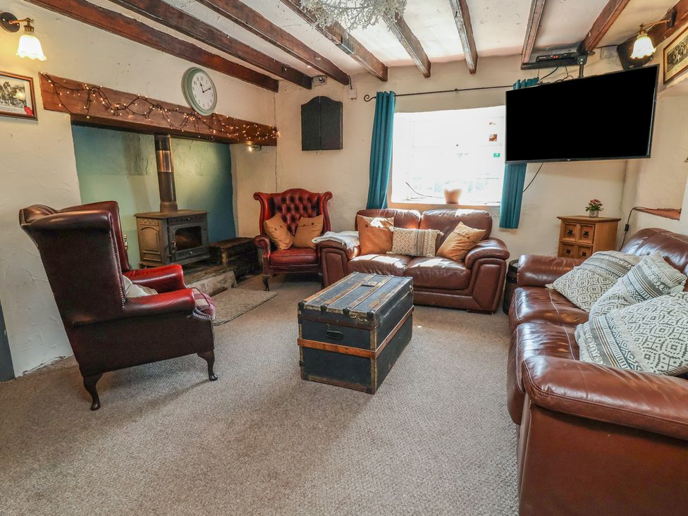 A living room with sofas and an armchair at The Sun Inn Apartment in Mold