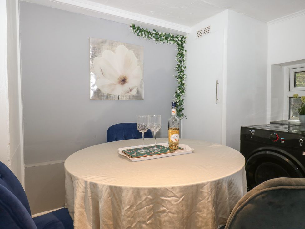 A dining area with a table and chairs at Chestnut Lodge in Bradford